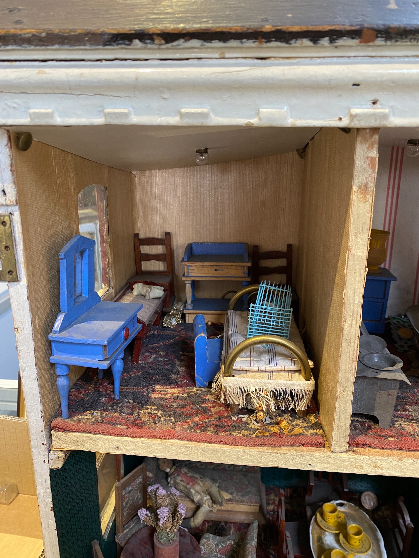 ‘Queens Lynn House’. A late 19th century home-made dolls' house, and contents, 66cm high